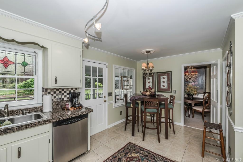 6737 Harrison Road Charlotte, NC 28270 - Photo 6 of 23 a kitchen with granite countertop a sink dining table and chairs