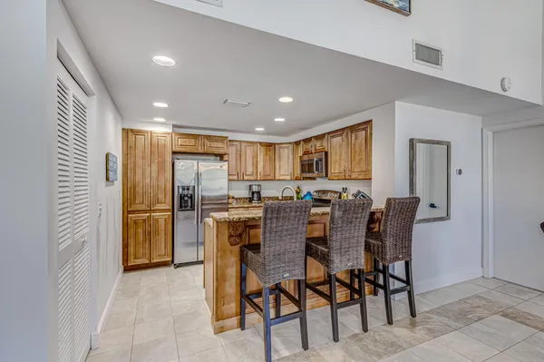 a view of a kitchen counter top space stove microwave and living room