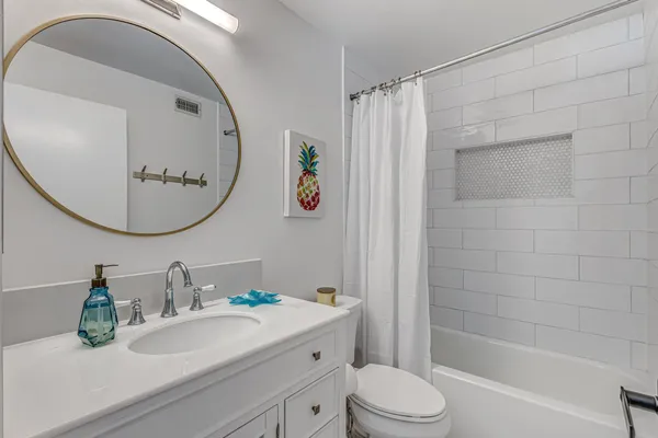 a view of a patio with couches table and chairs and potted plants
