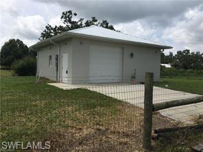 18759 Persimmon Ridge Road Alva, FL 33920 - Photo 2 of 23 a front view of a house with garden