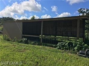 18759 Persimmon Ridge Road Alva, FL 33920 - Photo 8 of 23 a view of house with backyard and garden