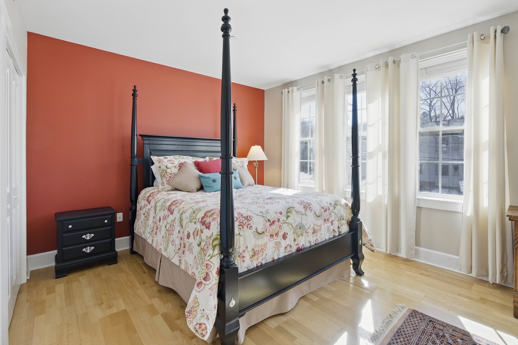 2 Powder Mill Square, Unit 2B Andover, MA 01810 - Photo 13 of 31 a large bed sitting in a bedroom next to a window