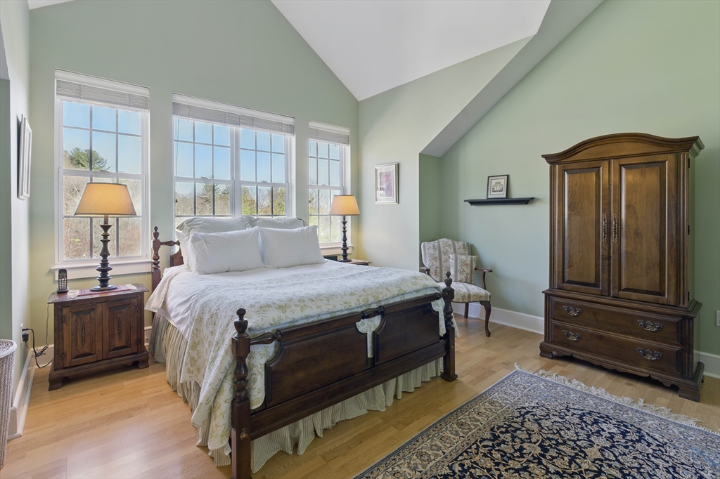 2 Powder Mill Square, Unit 2B Andover, MA 01810 - Photo 18 of 31 a spacious bedroom with a bed and a dresser in it