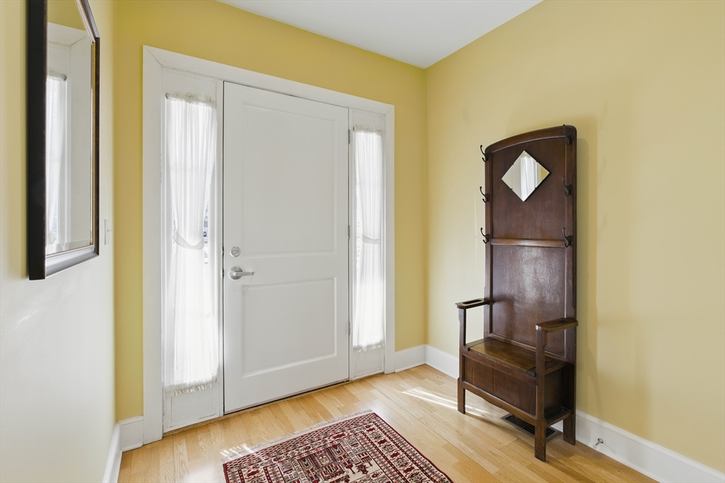 2 Powder Mill Square, Unit 2B Andover, MA 01810 - Photo 2 of 31 a view of a room with wooden floor cabinet and mirror