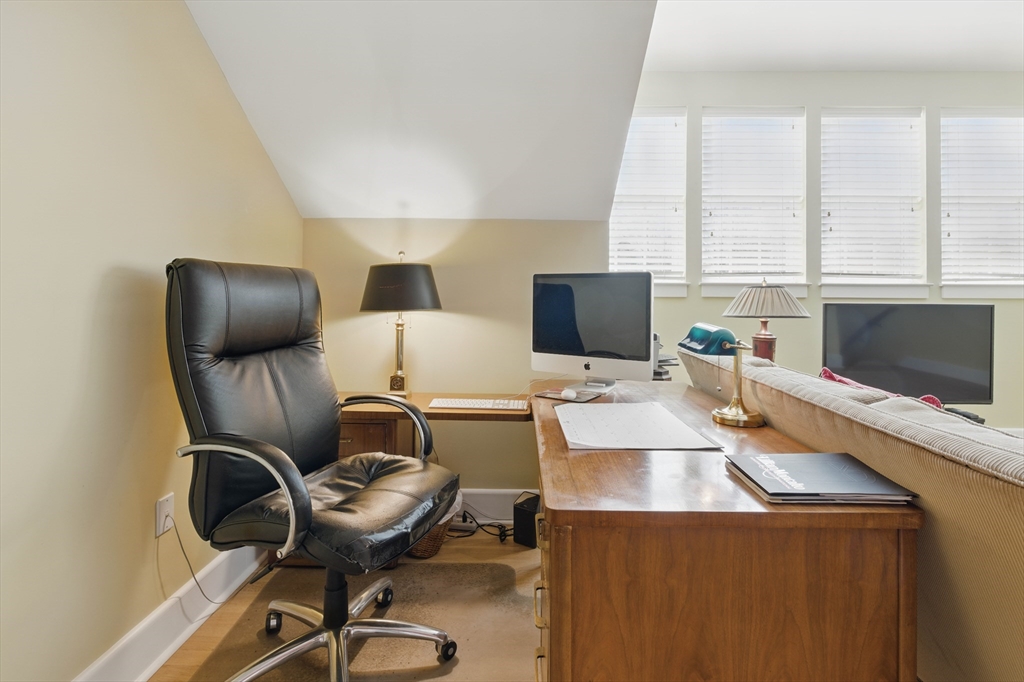 2 Powder Mill Square, Unit 2B Andover, MA 01810 - Photo 24 of 31 a work place with furniture and flat screen tv