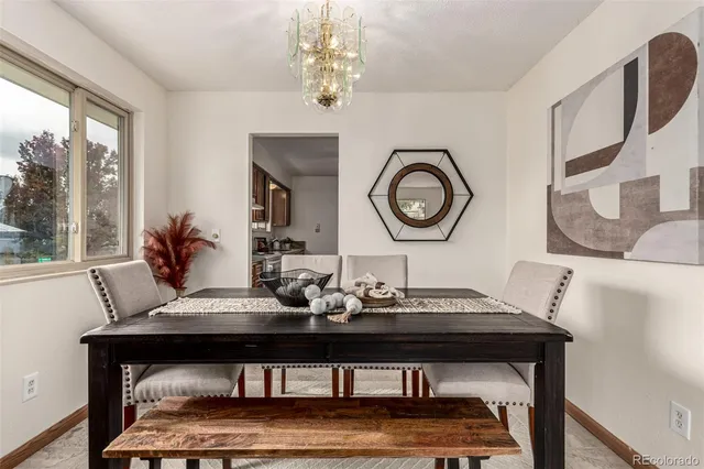 a view of a dining room with furniture and a large window
