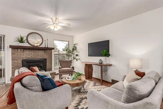 a living room with furniture and a fireplace