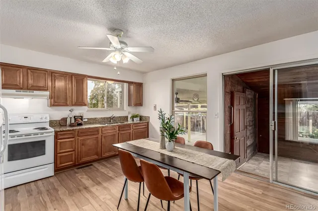 a kitchen with stove a sink and refrigerator