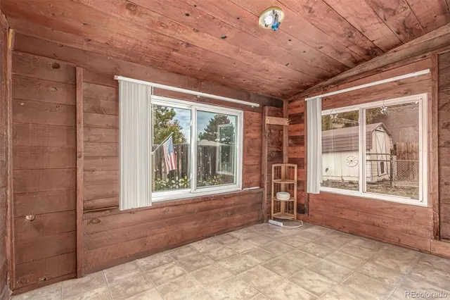 a view of an empty room with a fireplace and a large window