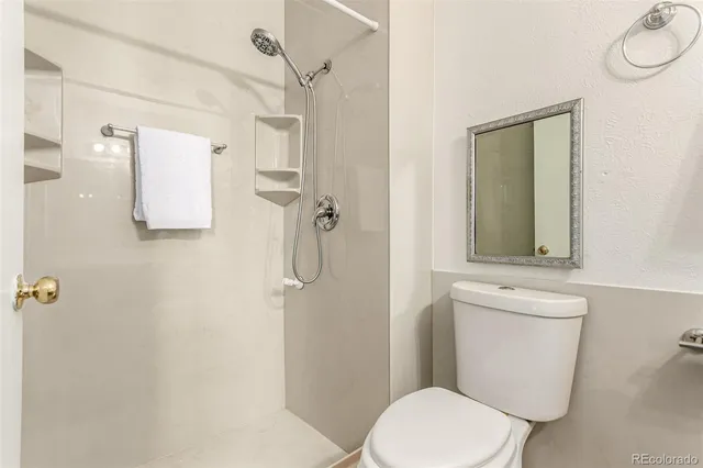 a bathroom with a toilet sink and shower