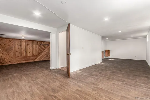 a view of an empty room and wooden floor
