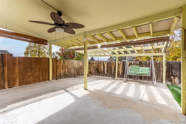 a view of a backyard with wooden fence
