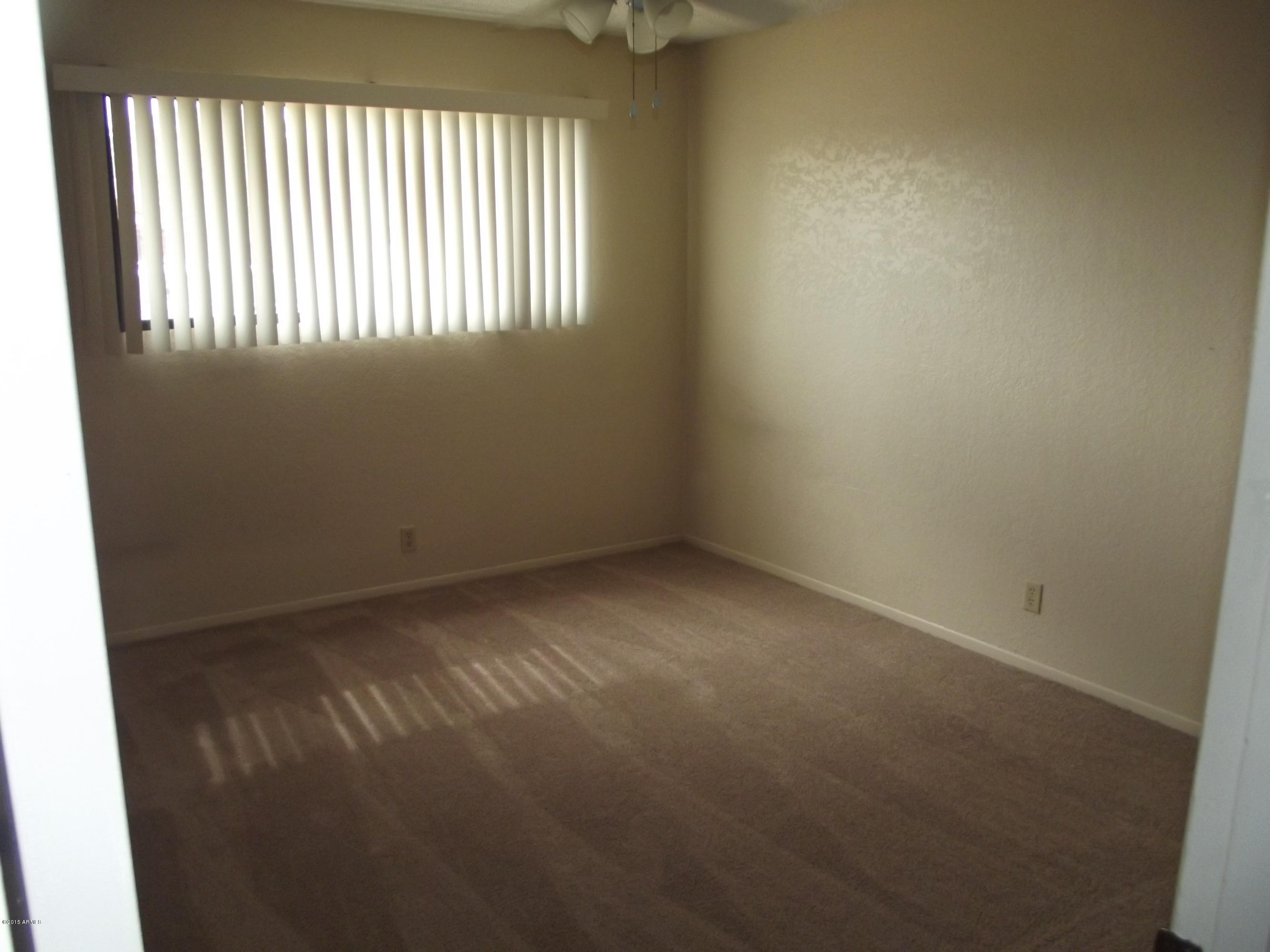 3144 West Bloomfield Road Phoenix, AZ 85029 - Photo 13 of 20 an empty room with windows