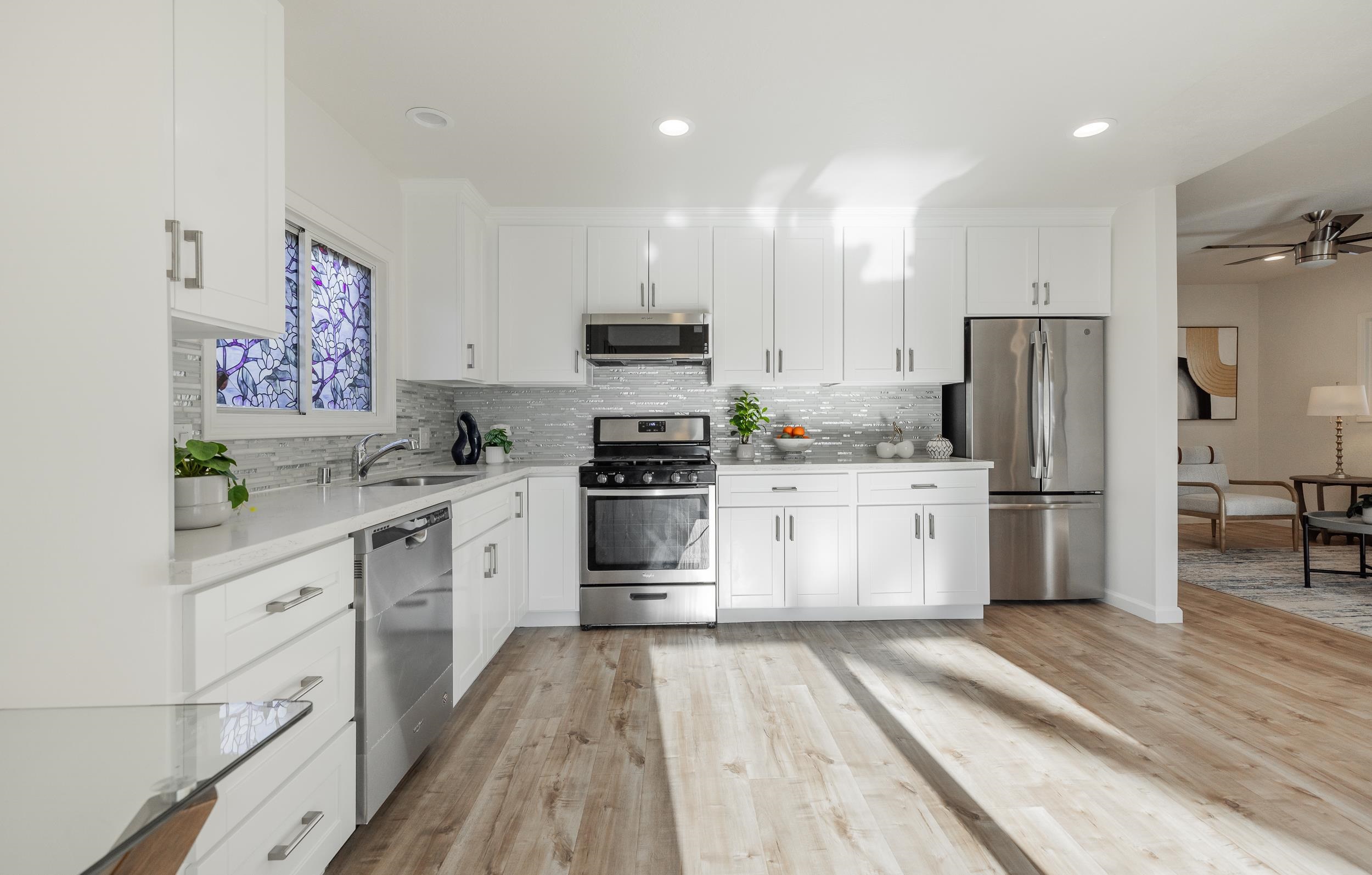 1900 Chestnut Street Santa Clara, CA 95054 - Photo 12 of 39 a kitchen with white cabinets and stainless steel appliances