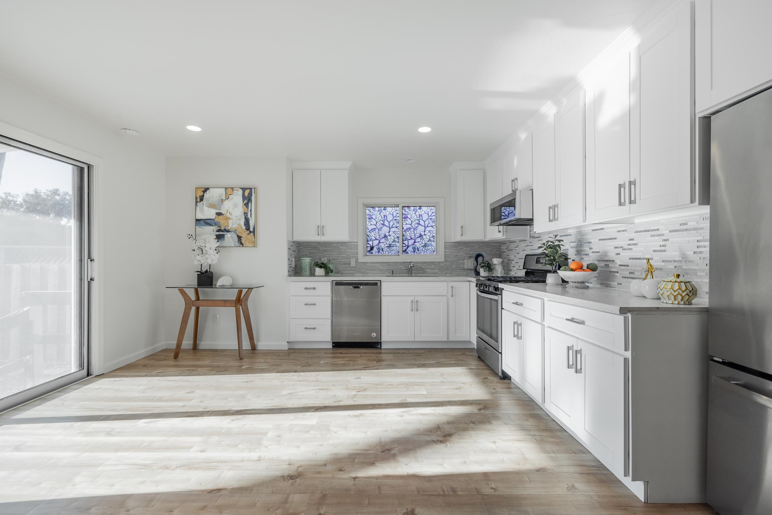 1900 Chestnut Street Santa Clara, CA 95054 - Photo 13 of 39 a kitchen with stainless steel appliances kitchen island granite countertop white cabinets and window