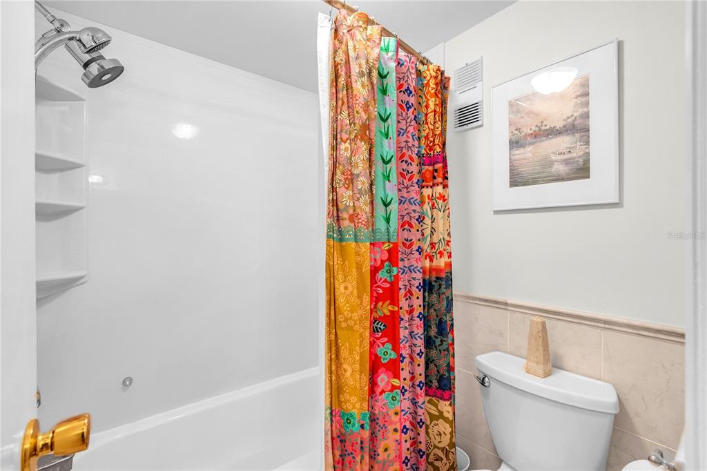 12200 Vonn Road, Unit 2206 Largo, FL 33774 - Photo 38 of 60 a bathroom with a toilet and a shower curtain