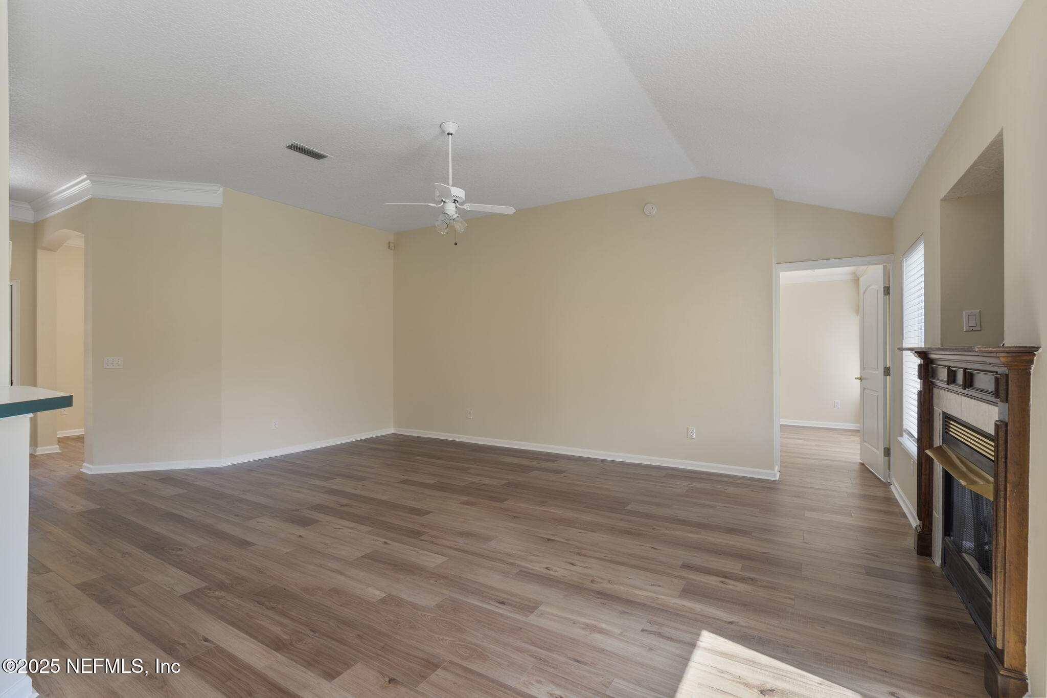 5673 Piper Glen Boulevard Jacksonville, FL 32222 - Photo 11 of 45 wooden floor in an empty room with a window