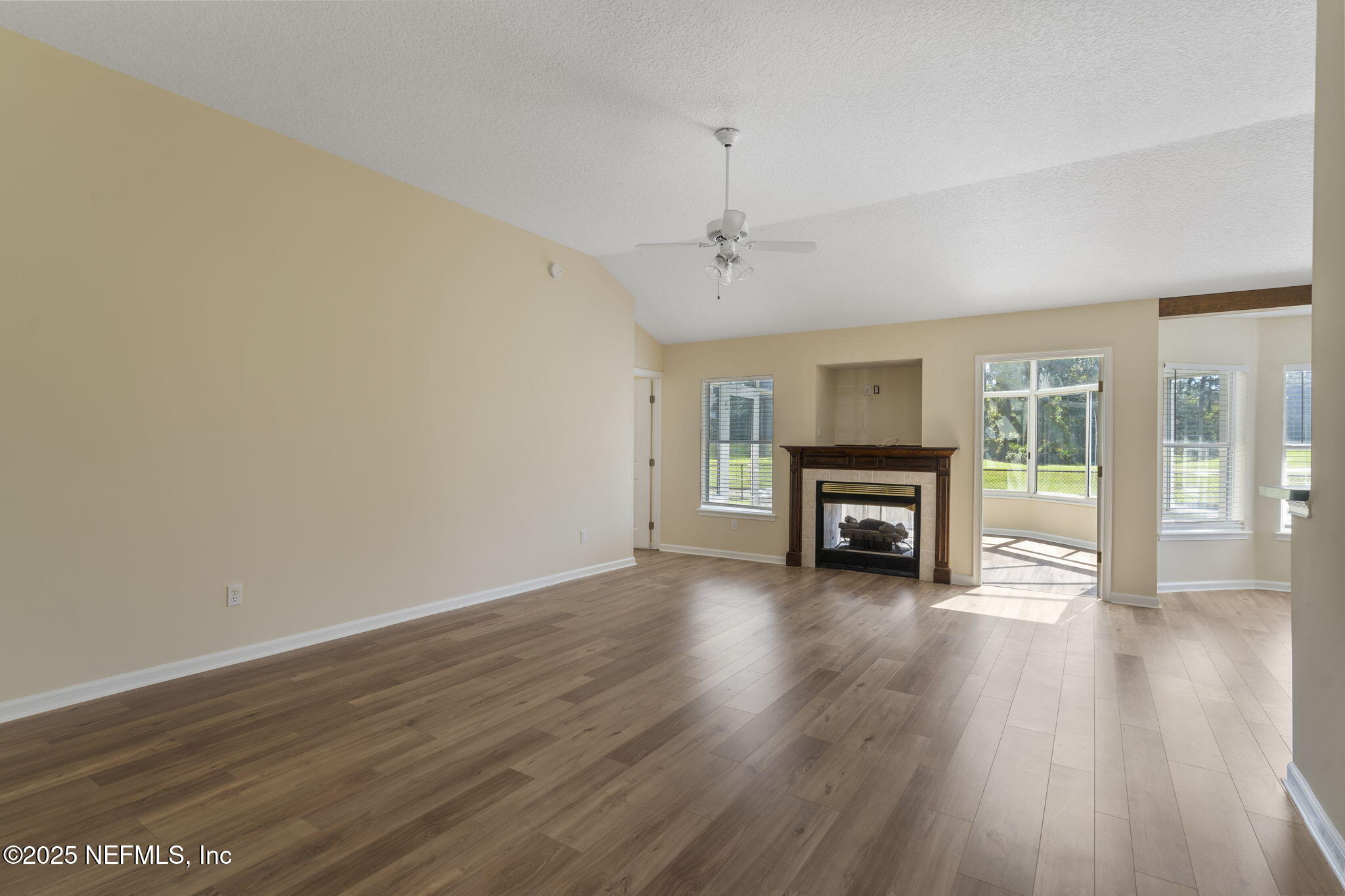5673 Piper Glen Boulevard Jacksonville, FL 32222 - Photo 13 of 45 a view of a livingroom with wooden floor and a ceiling fan