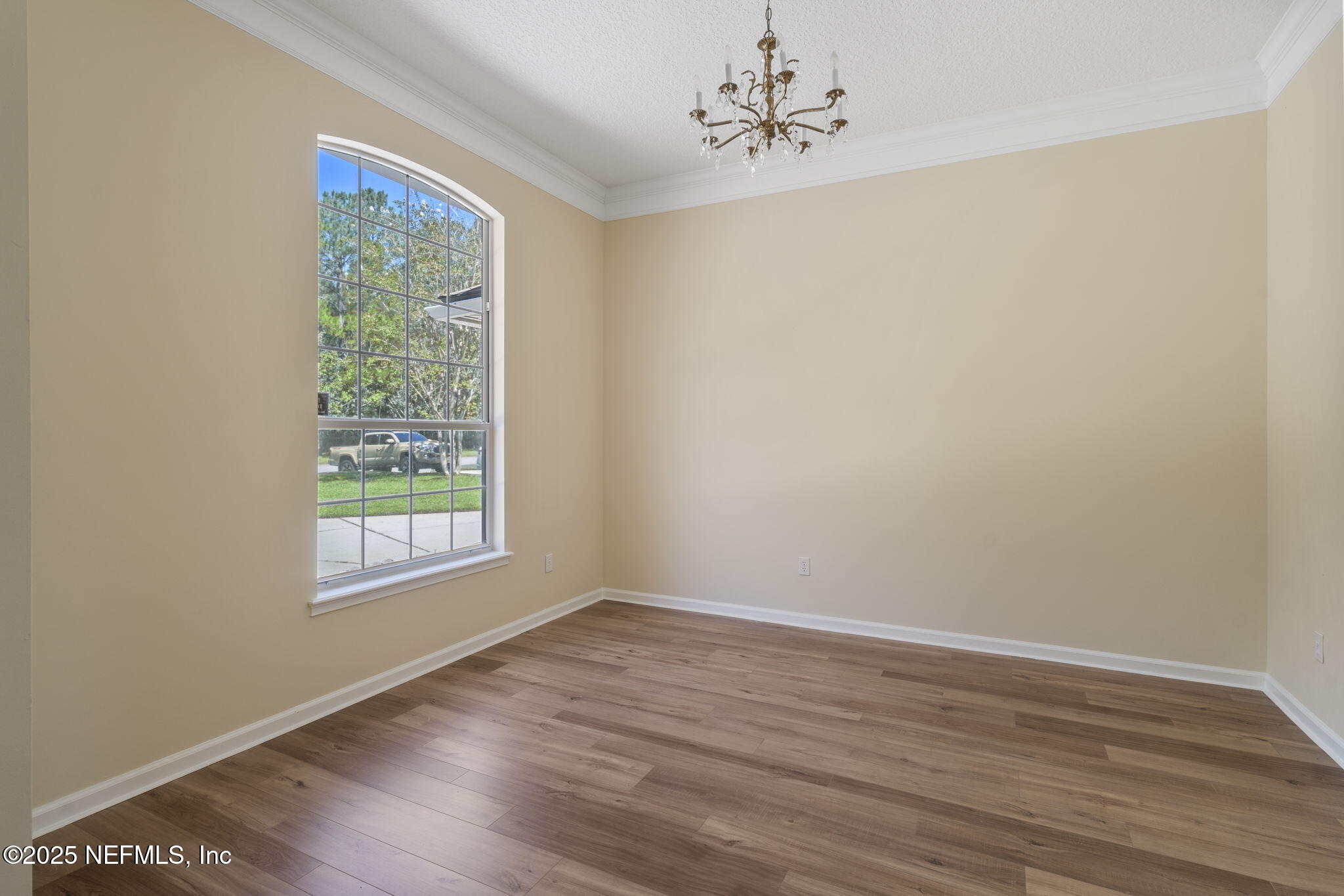 5673 Piper Glen Boulevard Jacksonville, FL 32222 - Photo 17 of 45 a view of an empty room with wooden floor and a window