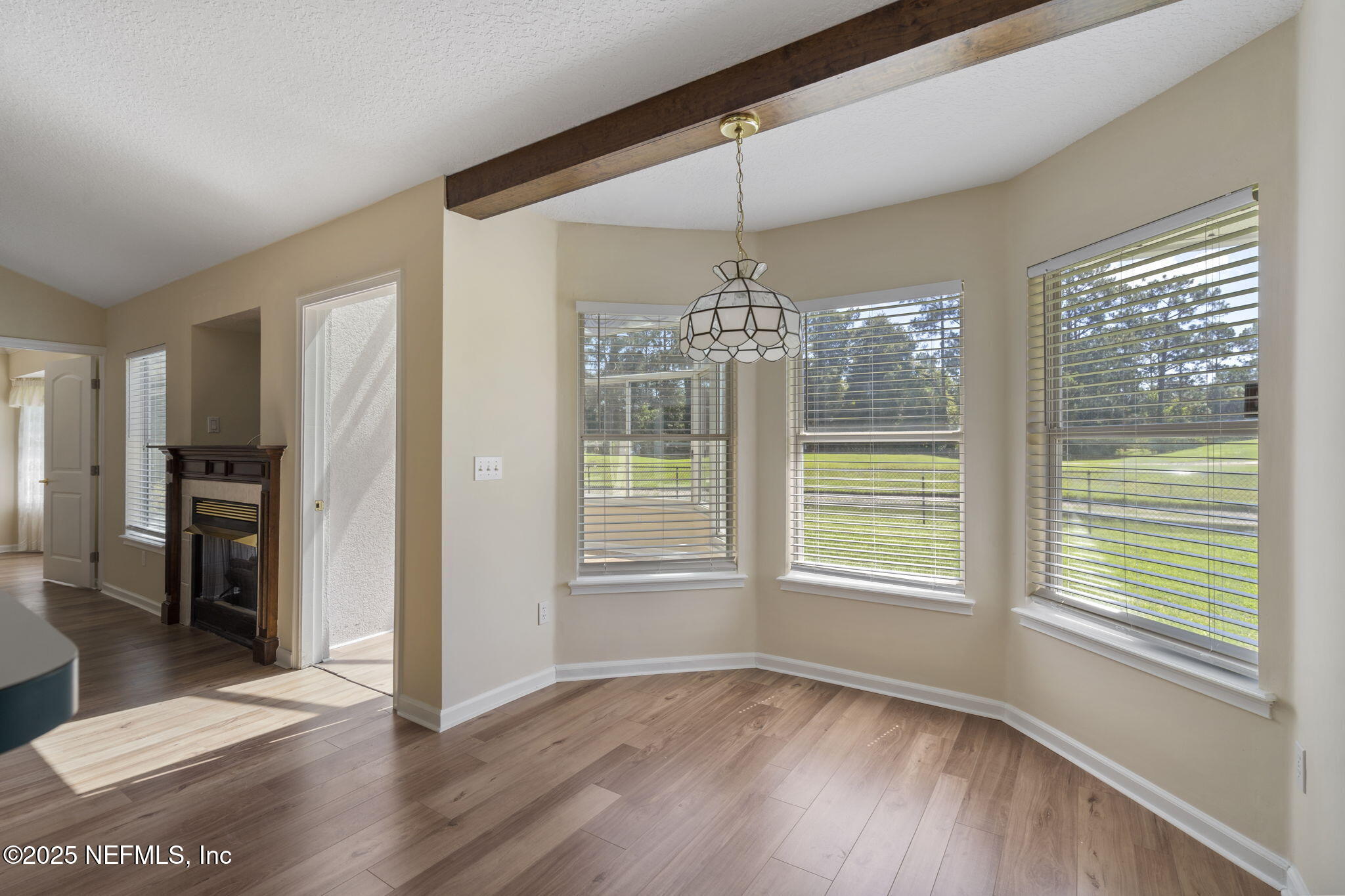 5673 Piper Glen Boulevard Jacksonville, FL 32222 - Photo 18 of 45 a view of an empty room with a window and wooden floor