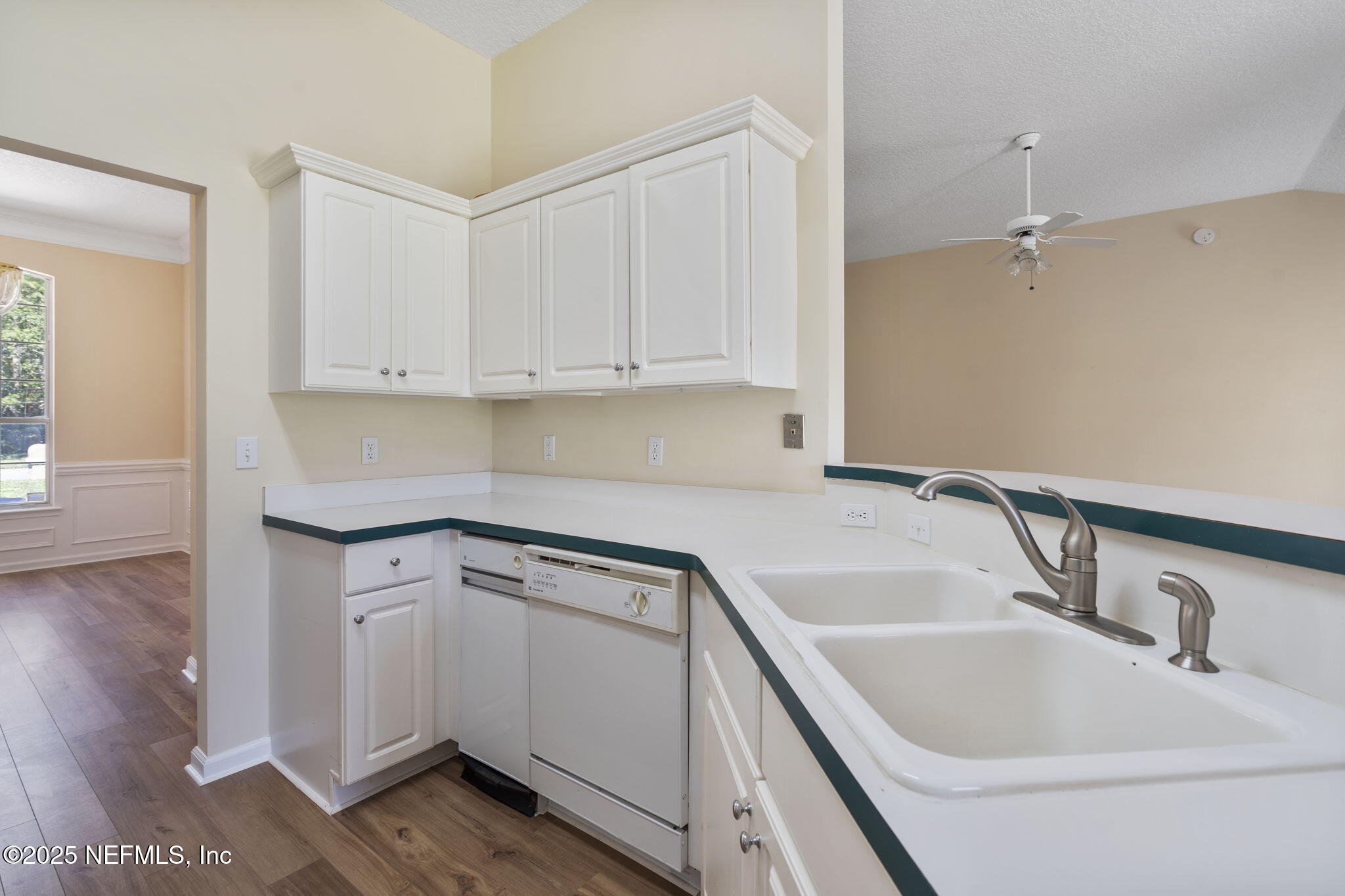 5673 Piper Glen Boulevard Jacksonville, FL 32222 - Photo 21 of 45 a kitchen with a sink cabinets and wooden floor