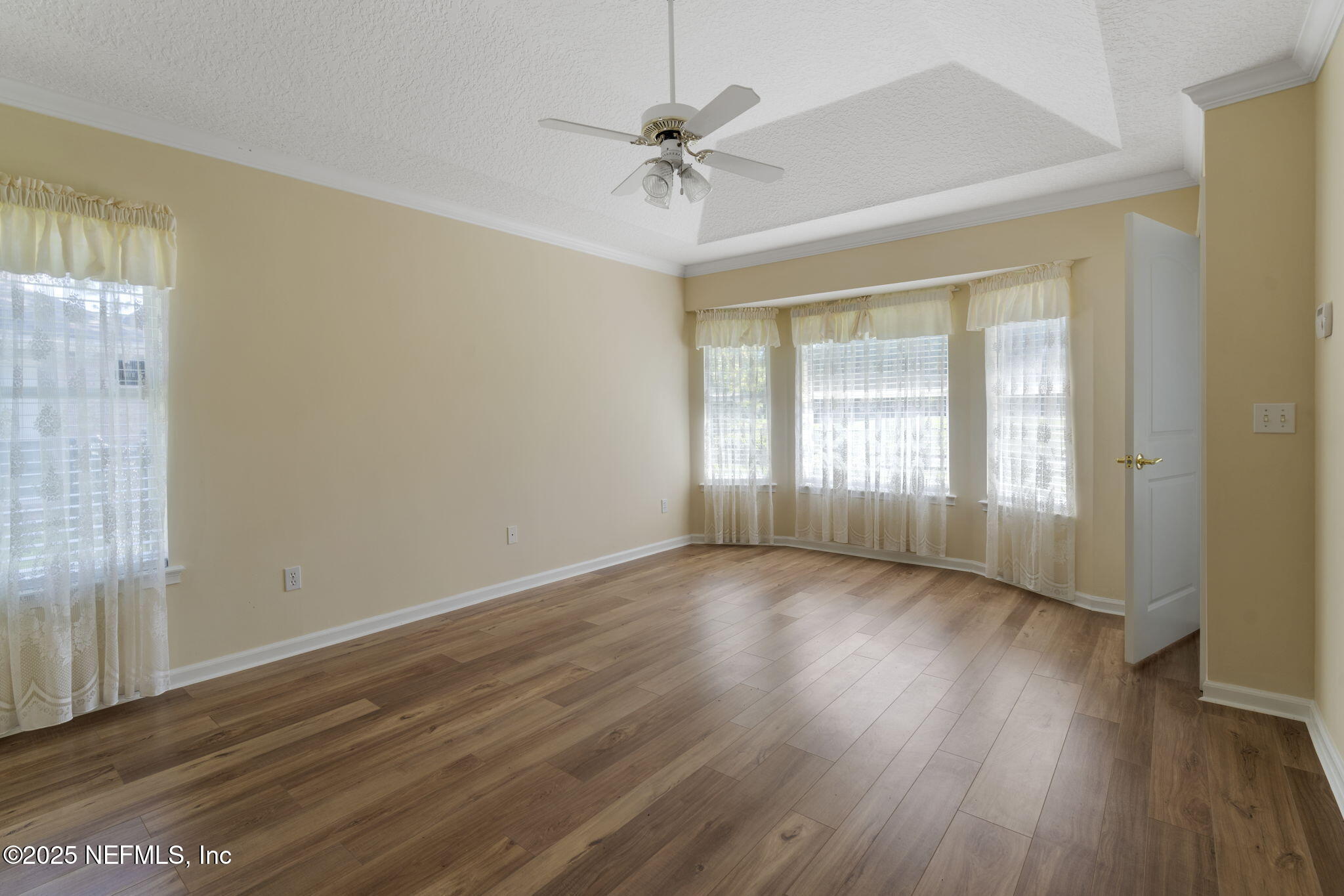 5673 Piper Glen Boulevard Jacksonville, FL 32222 - Photo 24 of 45 a view of an empty room with a window and wooden floor