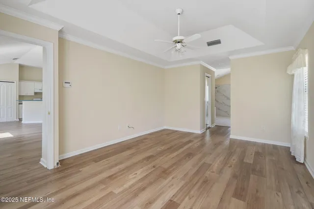 wooden floor in an empty room with a window