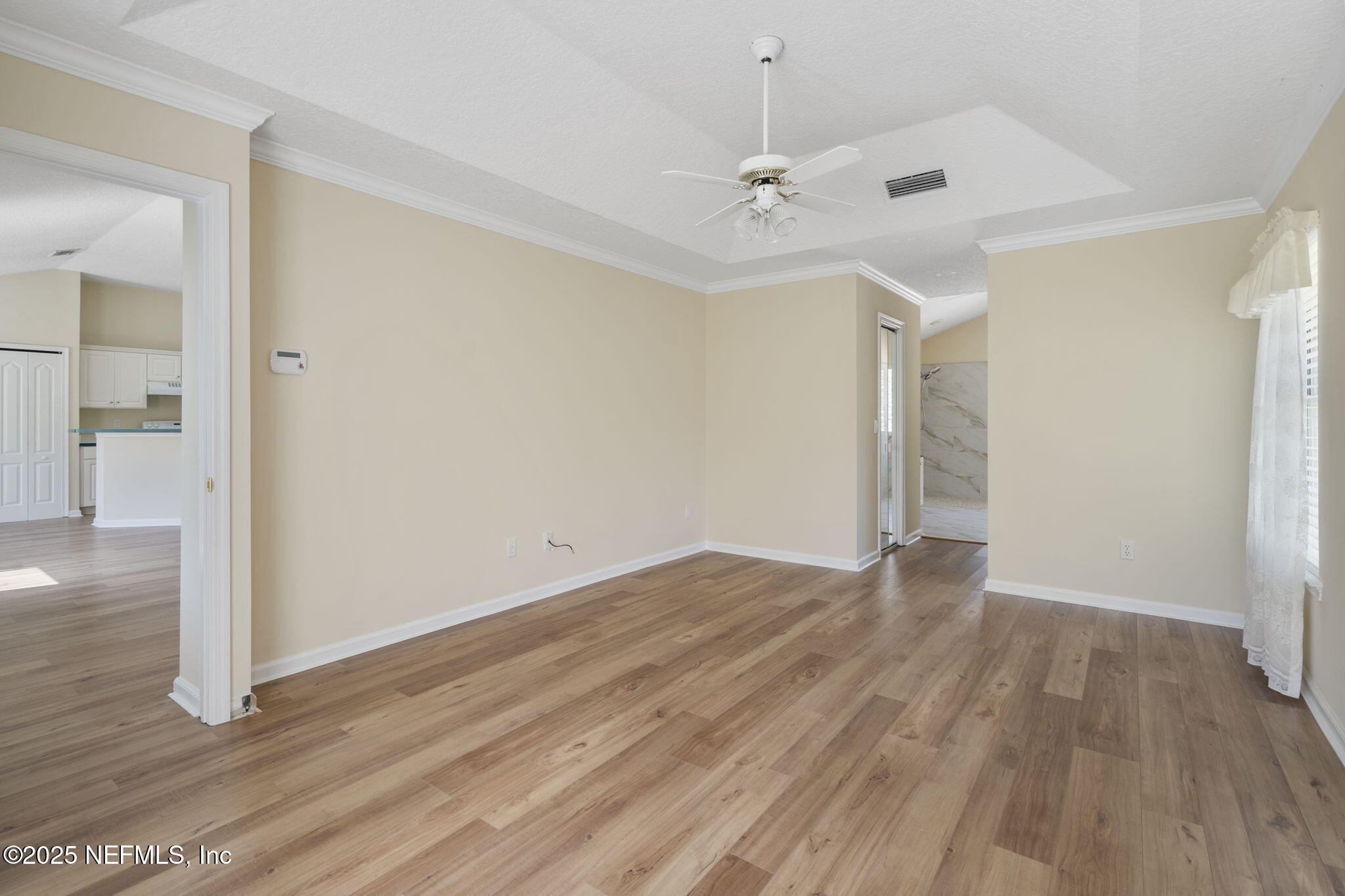 5673 Piper Glen Boulevard Jacksonville, FL 32222 - Photo 25 of 45 wooden floor in an empty room with a window
