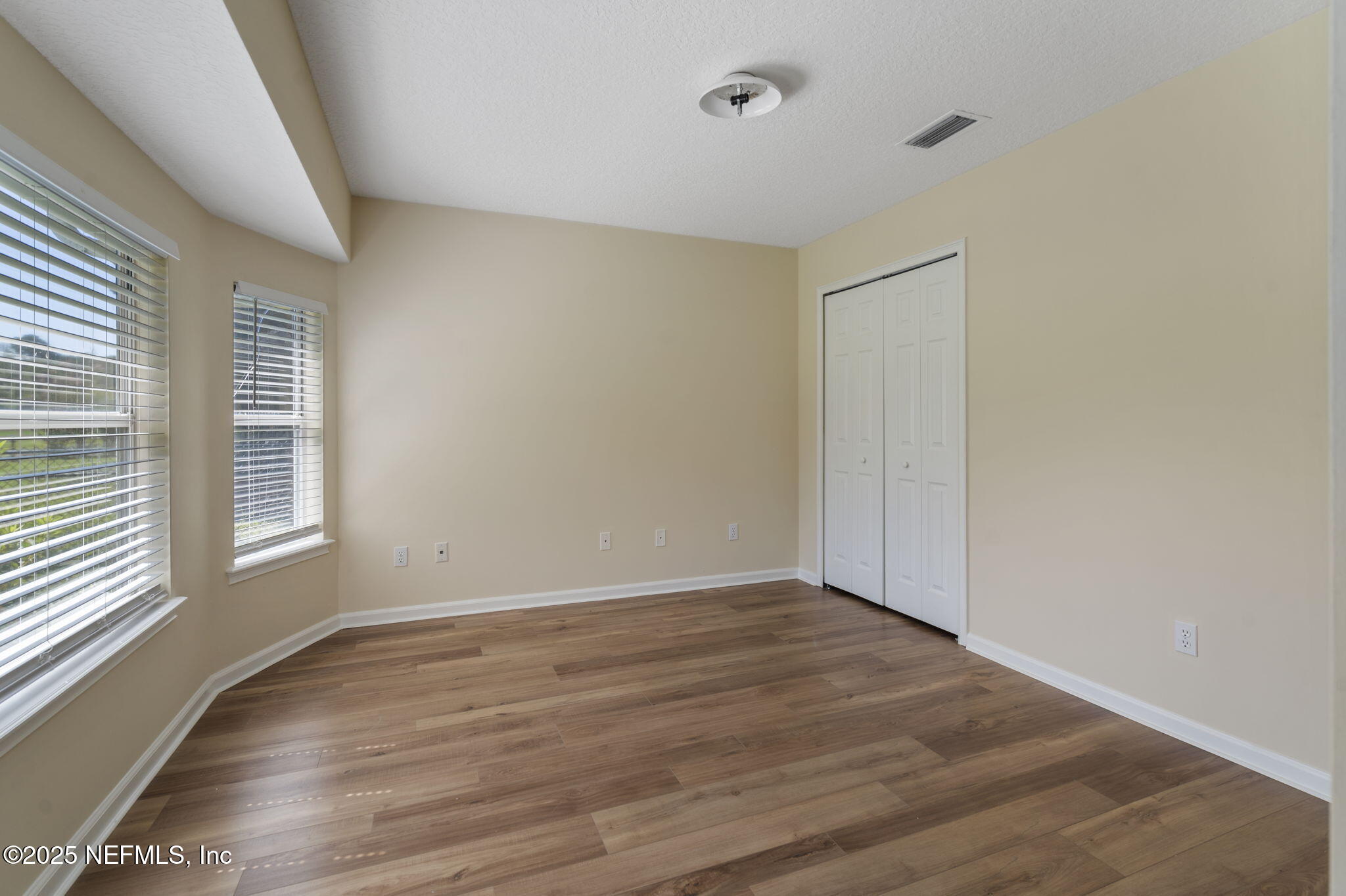 5673 Piper Glen Boulevard Jacksonville, FL 32222 - Photo 29 of 45 a view of an empty room with wooden floor and a window