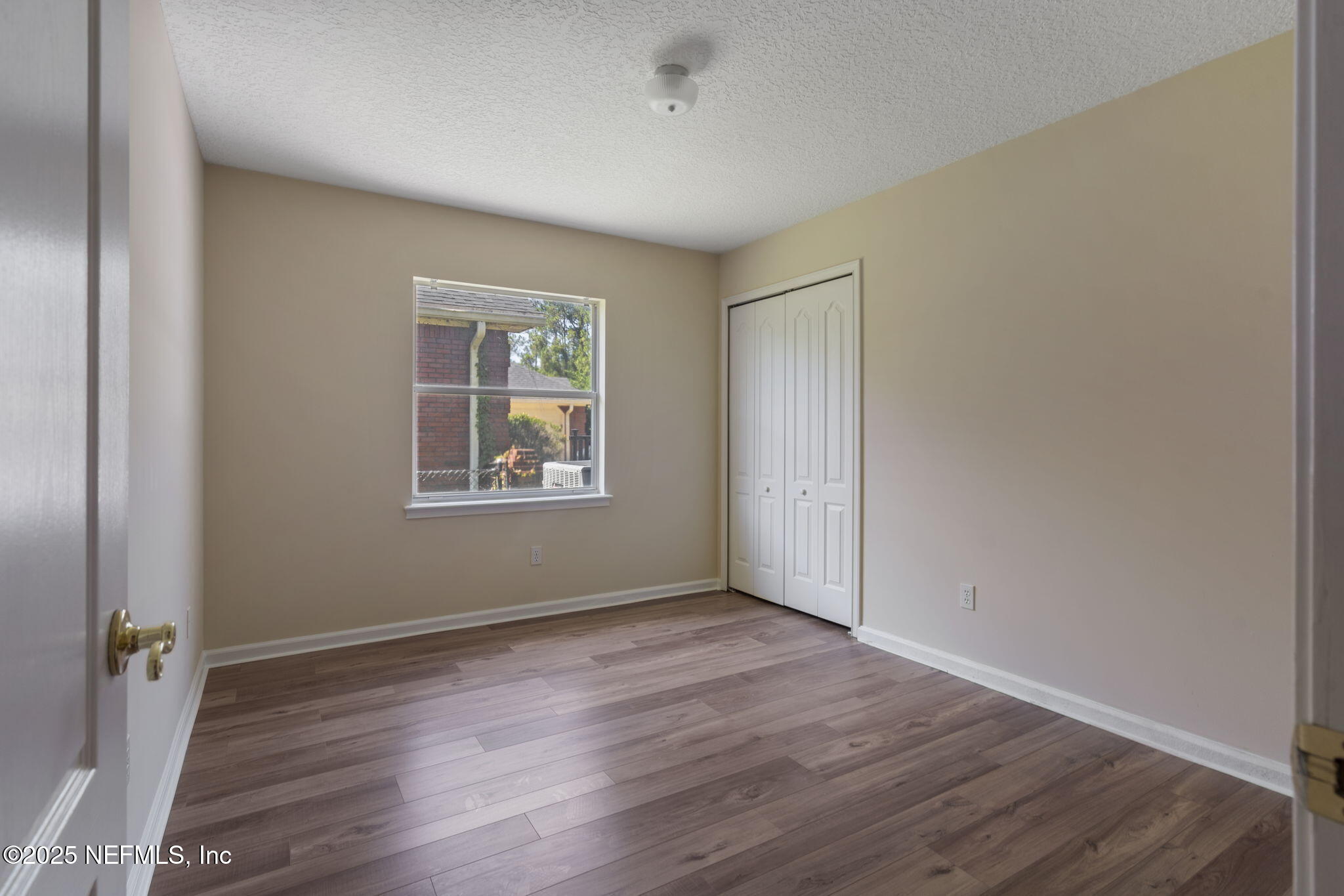 5673 Piper Glen Boulevard Jacksonville, FL 32222 - Photo 30 of 45 an empty room with wooden floor and windows