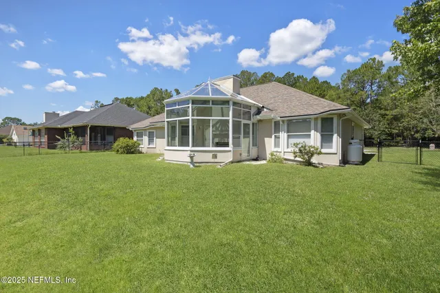 a front view of a house with a garden and plants