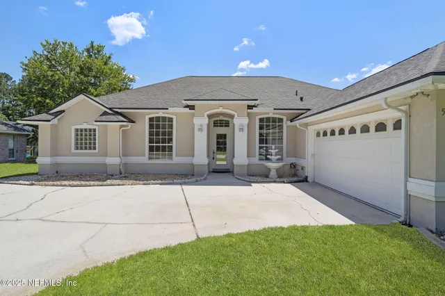 a front view of a house with a yard and garage