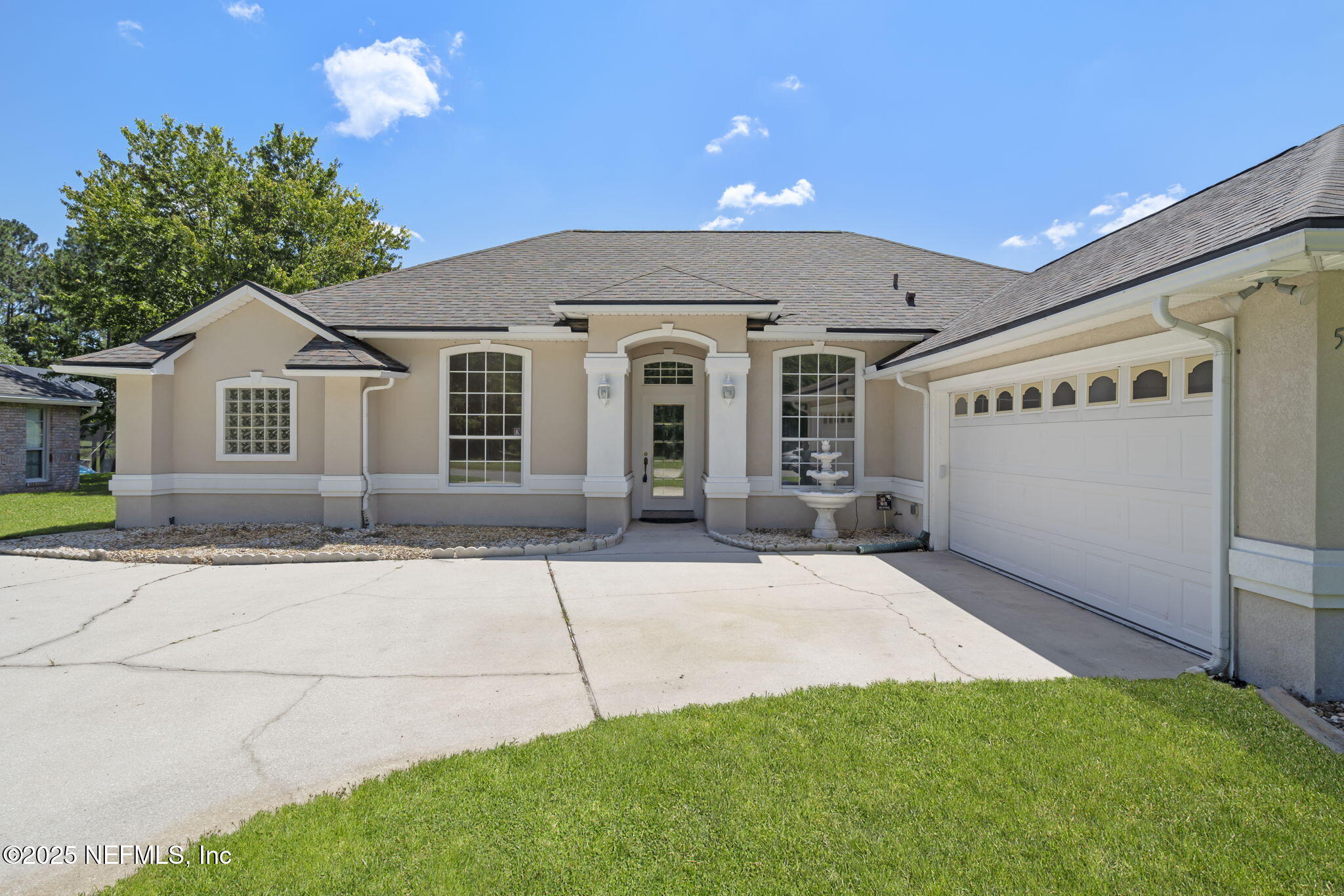5673 Piper Glen Boulevard Jacksonville, FL 32222 - Photo 4 of 45 a front view of a house with a yard and garage
