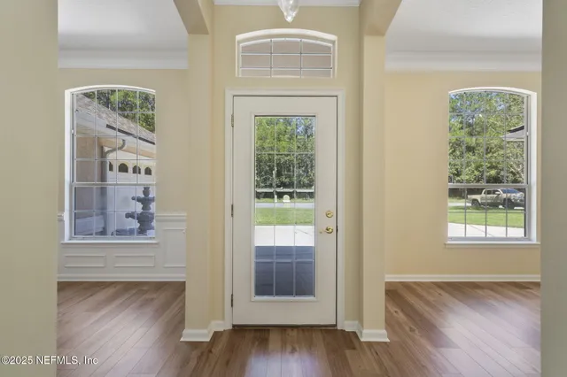 a view of an entryway with wooden floor
