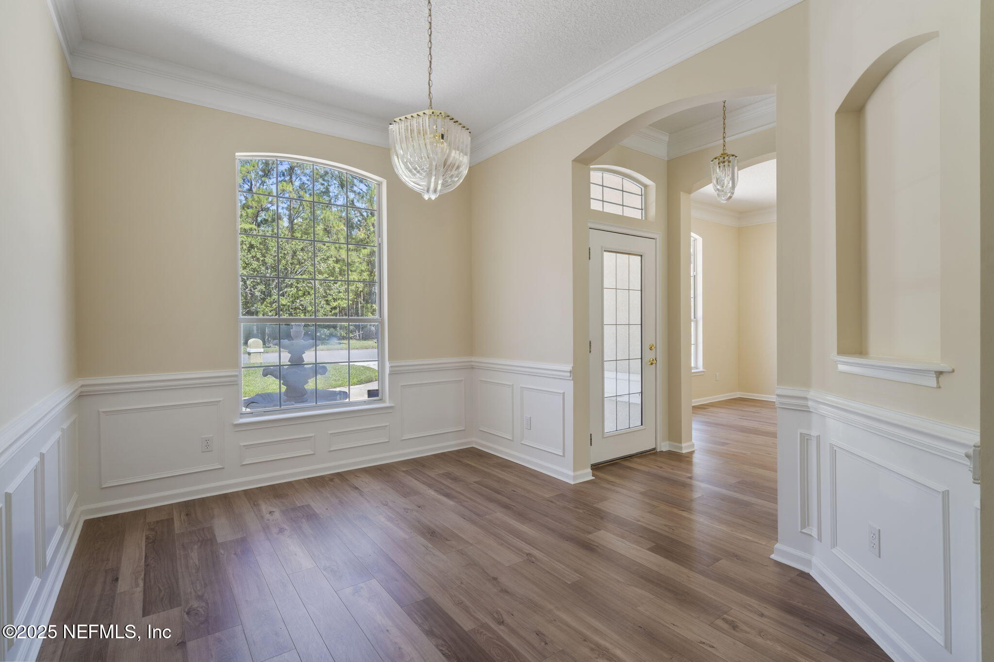 5673 Piper Glen Boulevard Jacksonville, FL 32222 - Photo 9 of 45 an empty room with wooden floor and windows