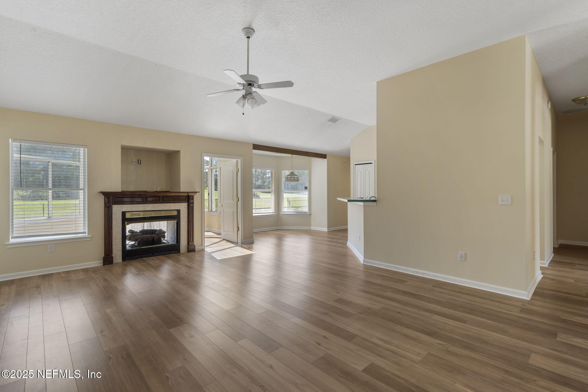 5673 Piper Glen Boulevard Jacksonville, FL 32222 - Photo 10 of 45 a view of an empty room with wooden floor and a window