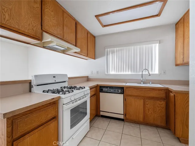 a kitchen with stainless steel appliances granite countertop a stove sink and cabinets