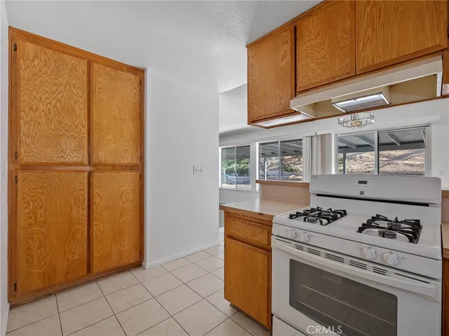a kitchen with granite countertop cabinets and appliances