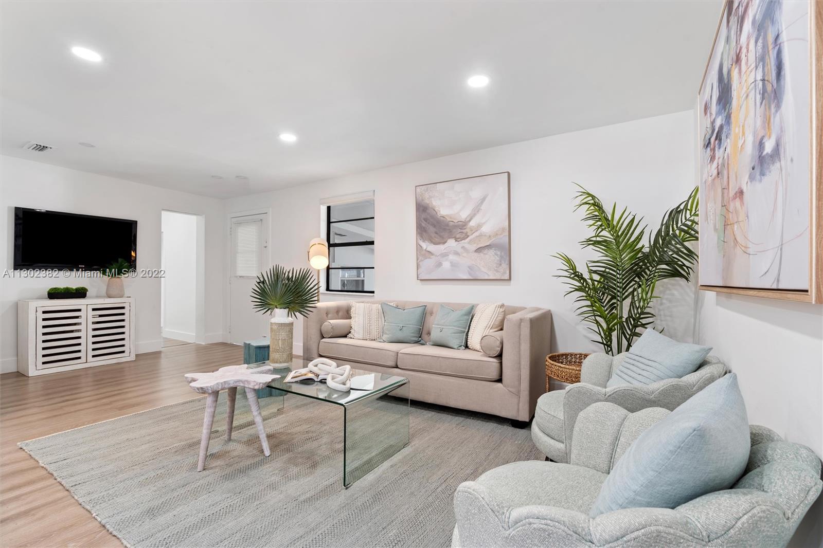 450 Flagami Boulevard Miami, FL 33144 - Photo 12 of 23 a living room with furniture a flat screen tv and a fireplace