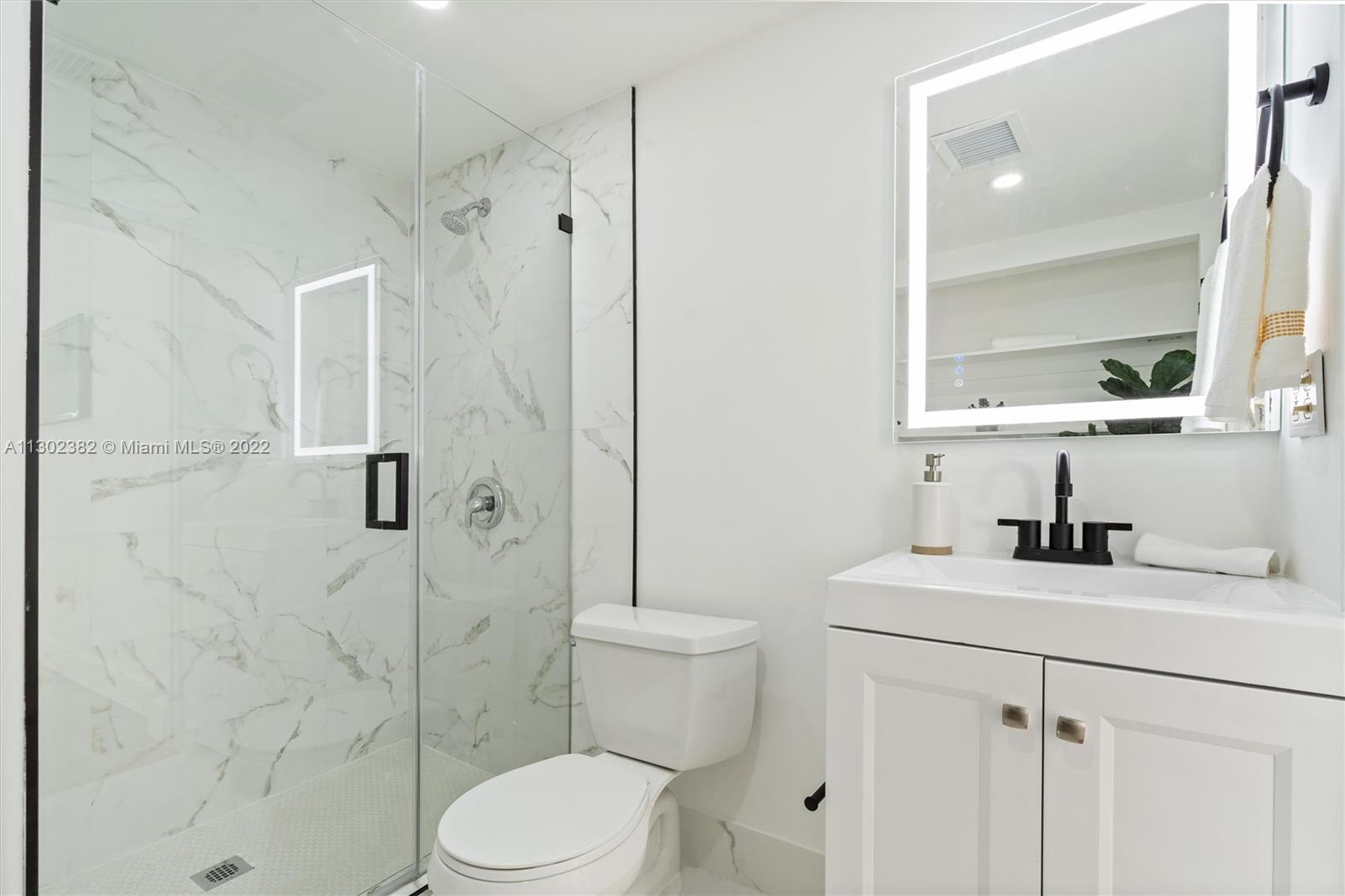 450 Flagami Boulevard Miami, FL 33144 - Photo 17 of 23 a bathroom with a sink toilet vanity and shower