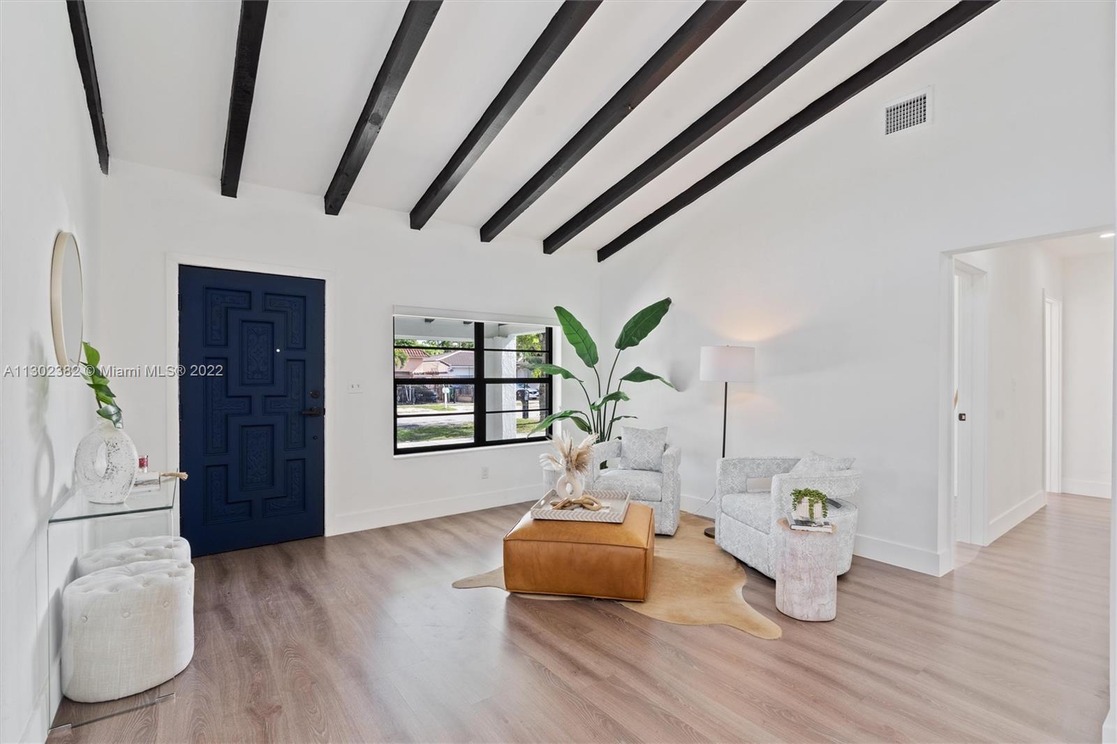 450 Flagami Boulevard Miami, FL 33144 - Photo 3 of 23 a living room with furniture and a wooden floor