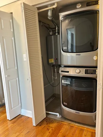a utility room with mirror and dryer