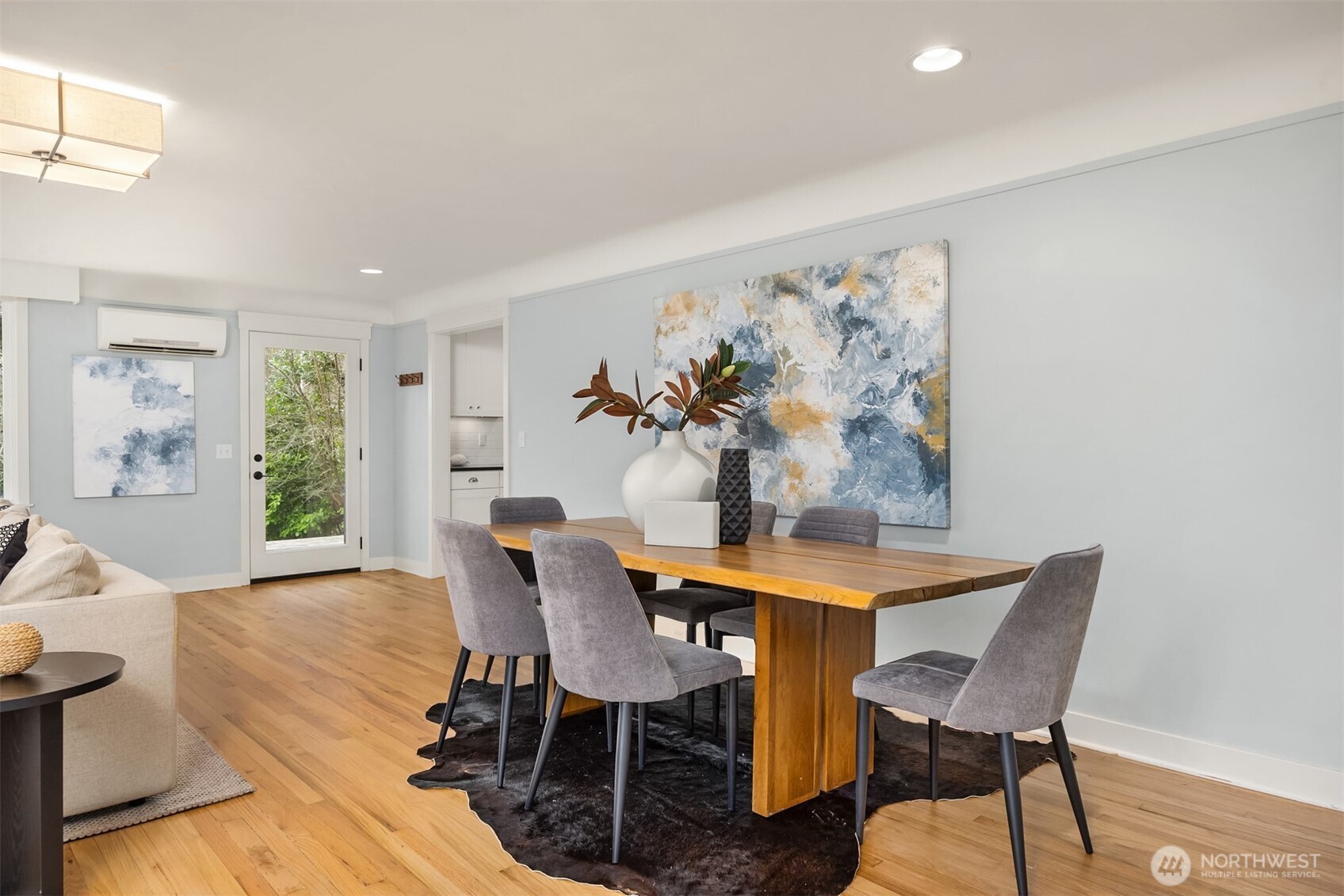 7204 Northeast Baker Hill Road Bainbridge Island, WA 98110 - Photo 12 of 40 a view of a dining room with furniture a potted plant and wooden floor