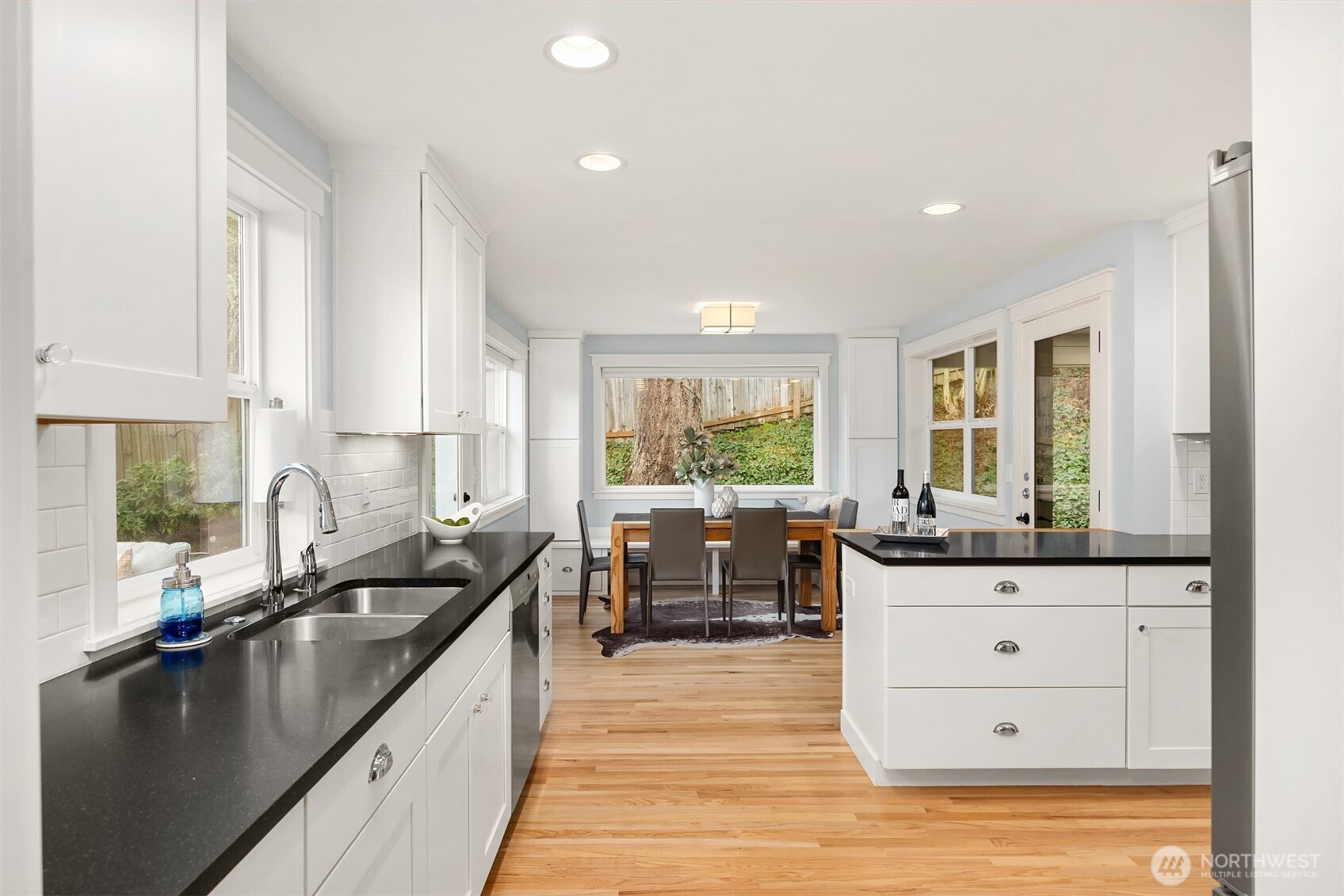 7204 Northeast Baker Hill Road Bainbridge Island, WA 98110 - Photo 15 of 40 a kitchen with granite countertop a sink stove and cabinets