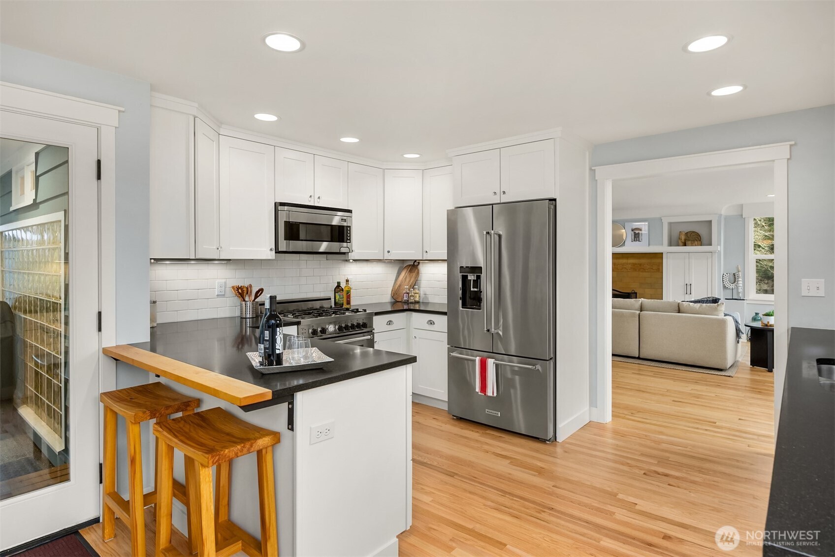 7204 Northeast Baker Hill Road Bainbridge Island, WA 98110 - Photo 16 of 40 a kitchen with refrigerator a microwave a sink and cabinets