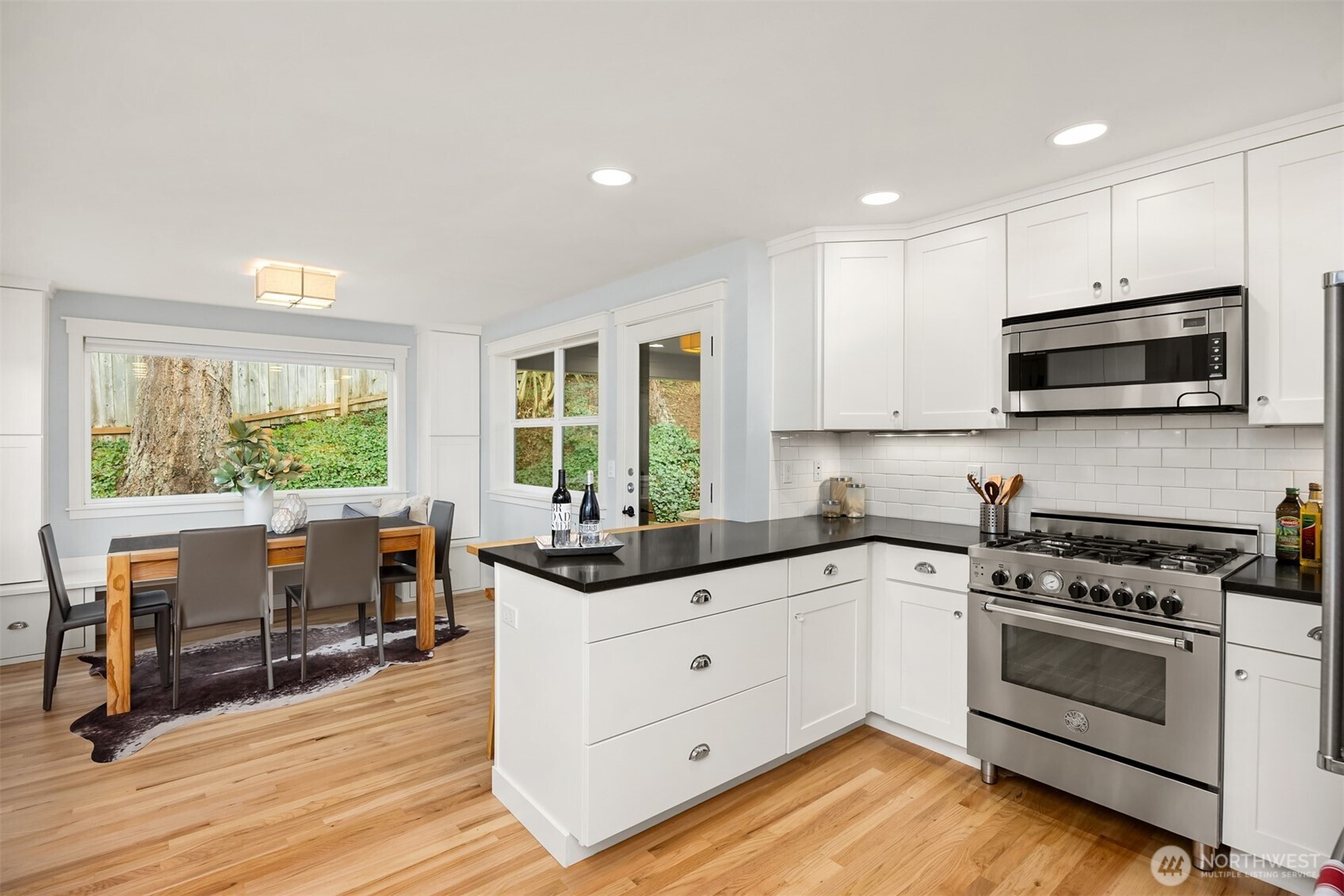 7204 Northeast Baker Hill Road Bainbridge Island, WA 98110 - Photo 17 of 40 a kitchen with a stove a sink and a microwave