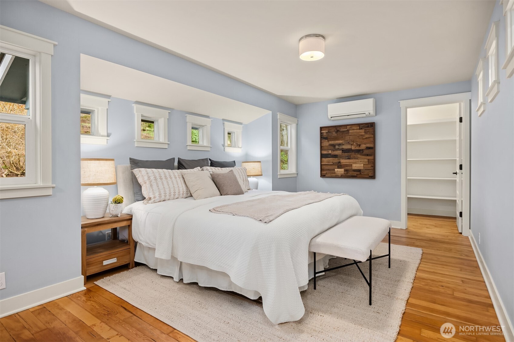 7204 Northeast Baker Hill Road Bainbridge Island, WA 98110 - Photo 18 of 40 a bedroom with a bed and a table