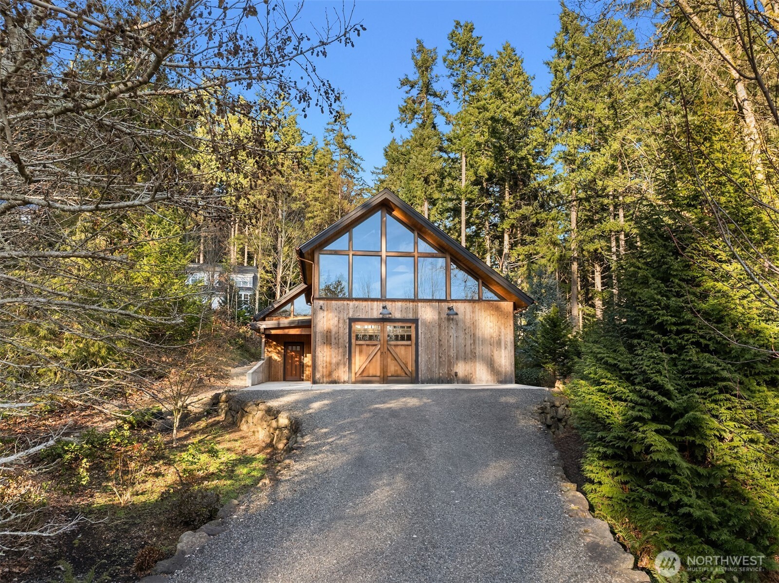 7204 Northeast Baker Hill Road Bainbridge Island, WA 98110 - Photo 27 of 40 a front view of a house with a yard