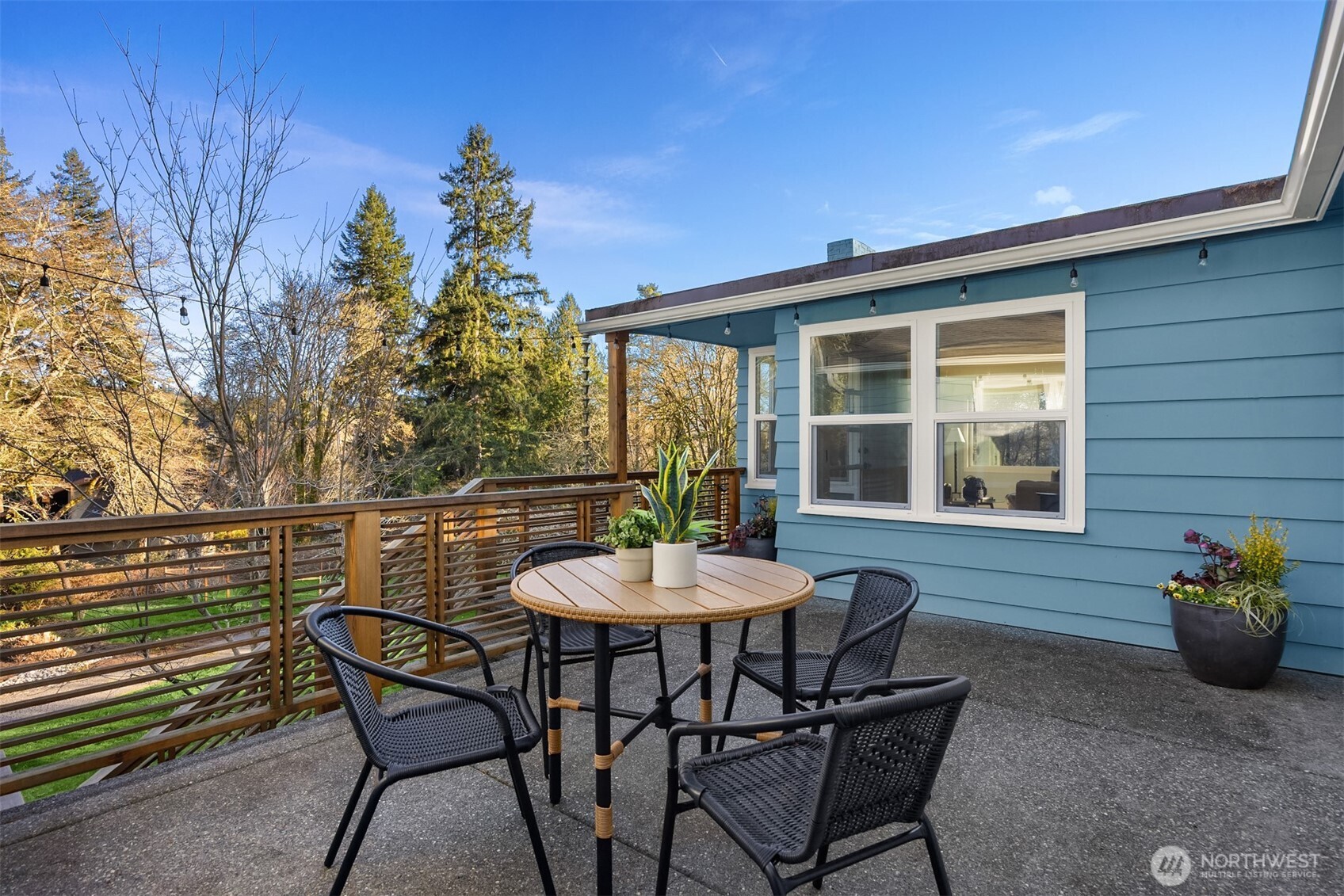 7204 Northeast Baker Hill Road Bainbridge Island, WA 98110 - Photo 7 of 40 a view of a patio with a table and chairs