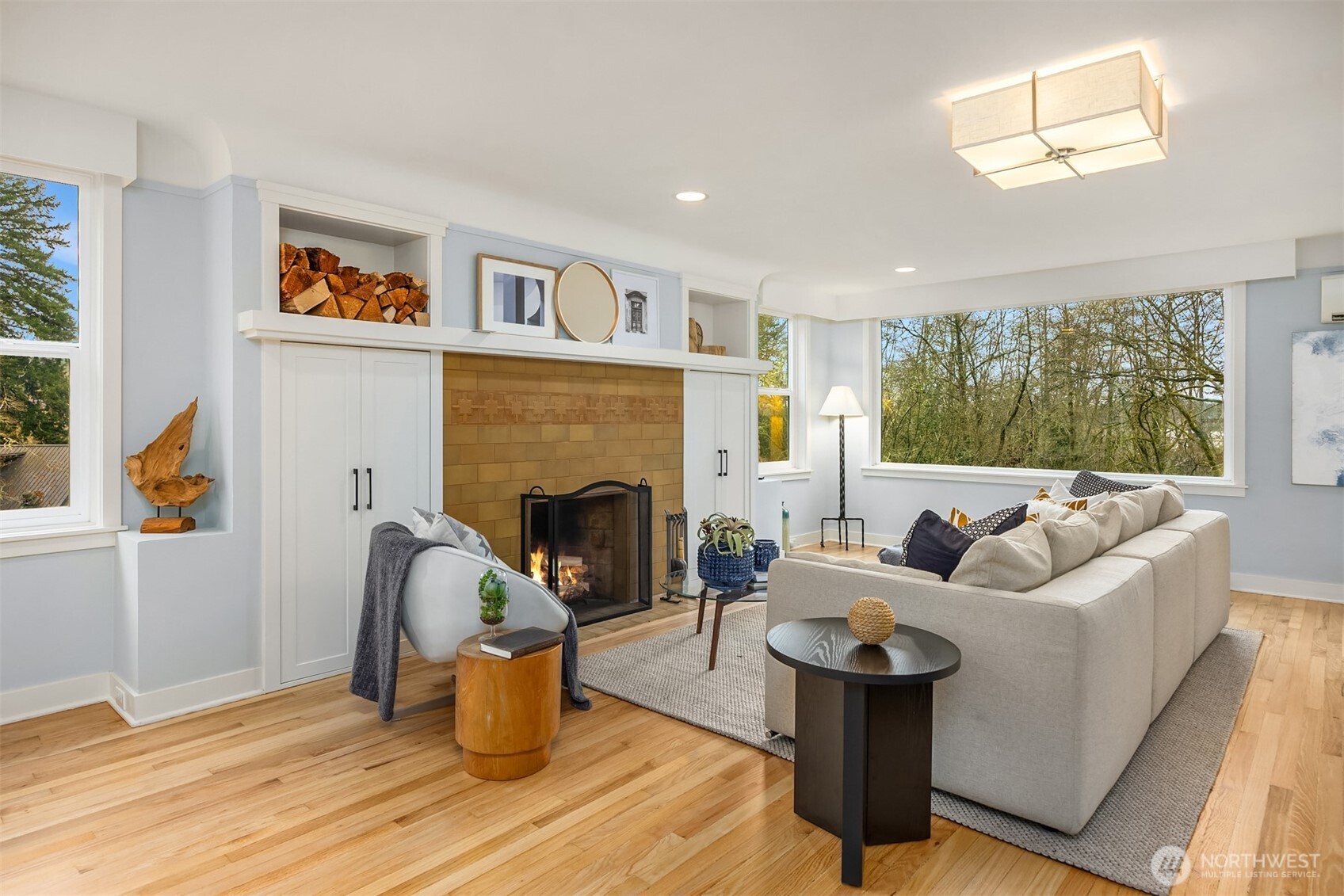 7204 Northeast Baker Hill Road Bainbridge Island, WA 98110 - Photo 10 of 40 a living room with furniture and a fireplace